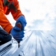Close up photo of Professional and qualified roofer in protective uniform wear use electric drill to install the m