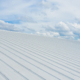 Metal sheet roofing on commercial construction with blue sky