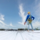 Worker drilling into new metal roof